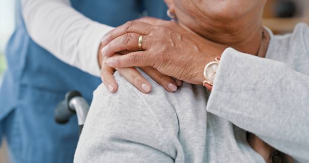 Nurse, holding hands and push wheelchair for person with disability, rehabilitation or help in closeup at clinic. Caregiver, doctor and patient in hospital recovery for physiotherapy with kindness