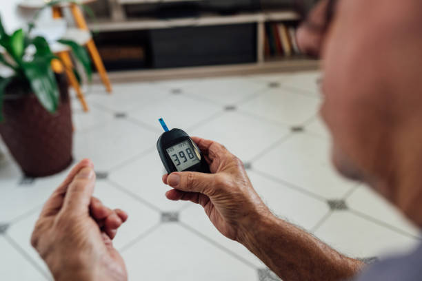 Man checking blood sugar on portable glucometer