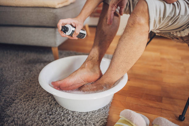 Man relaxing at home having a foot bath